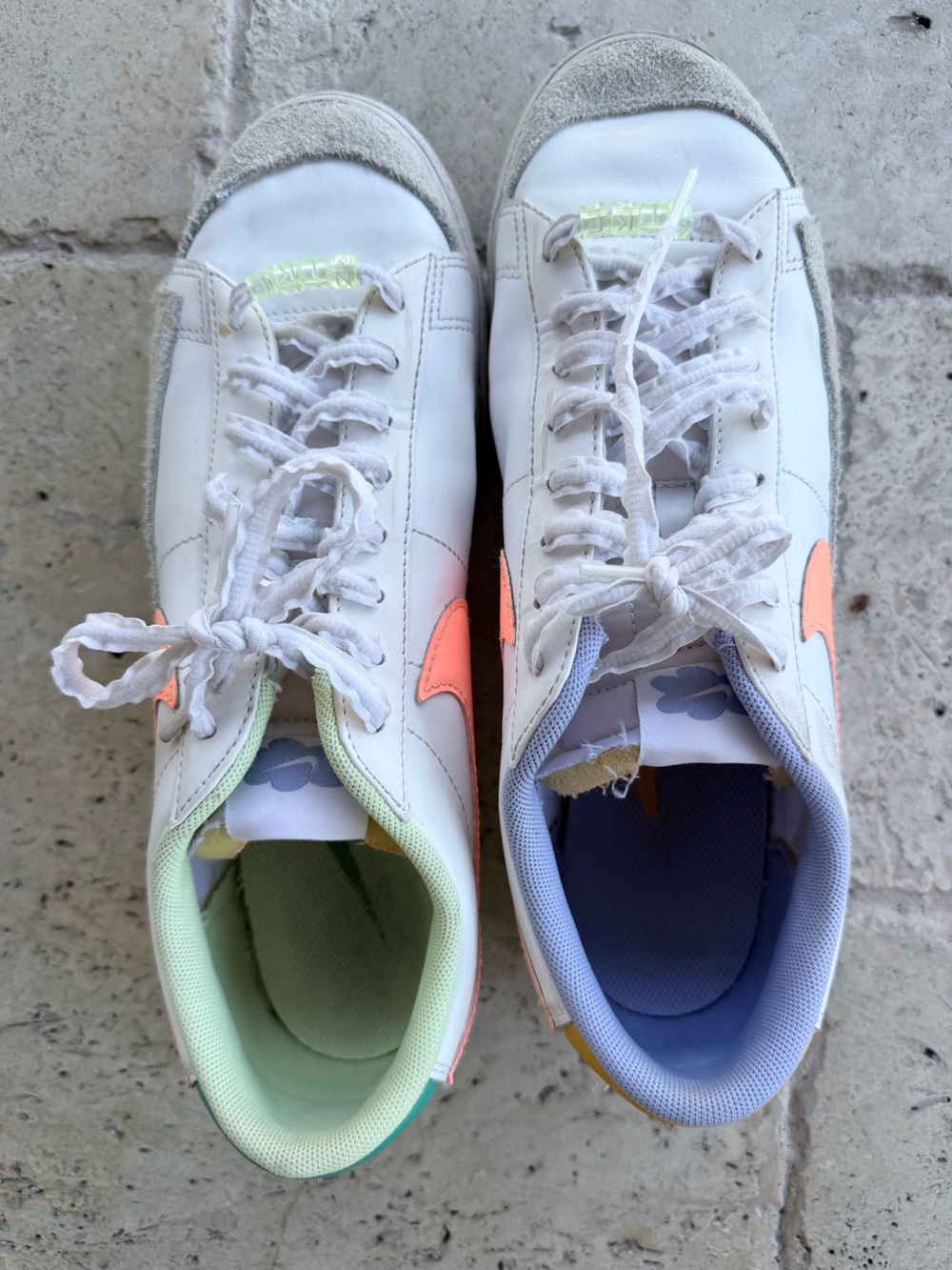 Nike Kids White Sneakers with Coral Swoosh and Pastel Linings